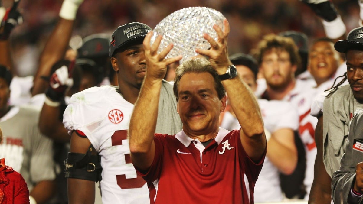 Head coach Nick Saban of the Alabama Crimson Tide celebrates with the BCS Coaches' Trophy.