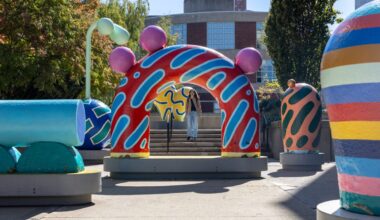 A student walks past colorful statues near Stearns Center Oct. 7. Northeastern enrolled over 7,000 Class of 2030 undergraduate students to all of its campuses this fall.