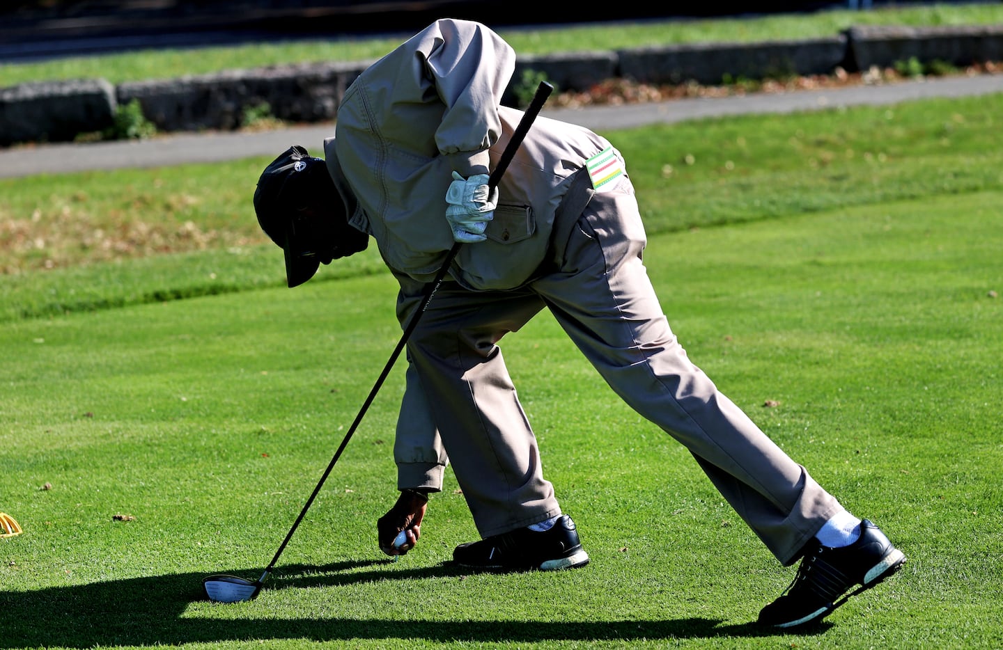 George O. Jones placing his golf tee. 