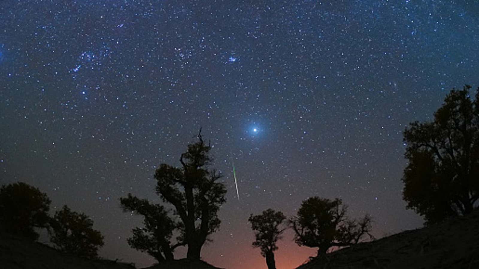 A meteor streaks across the sky over a desert in China during the Orionid meteor shower on Oct. 22, 2023.