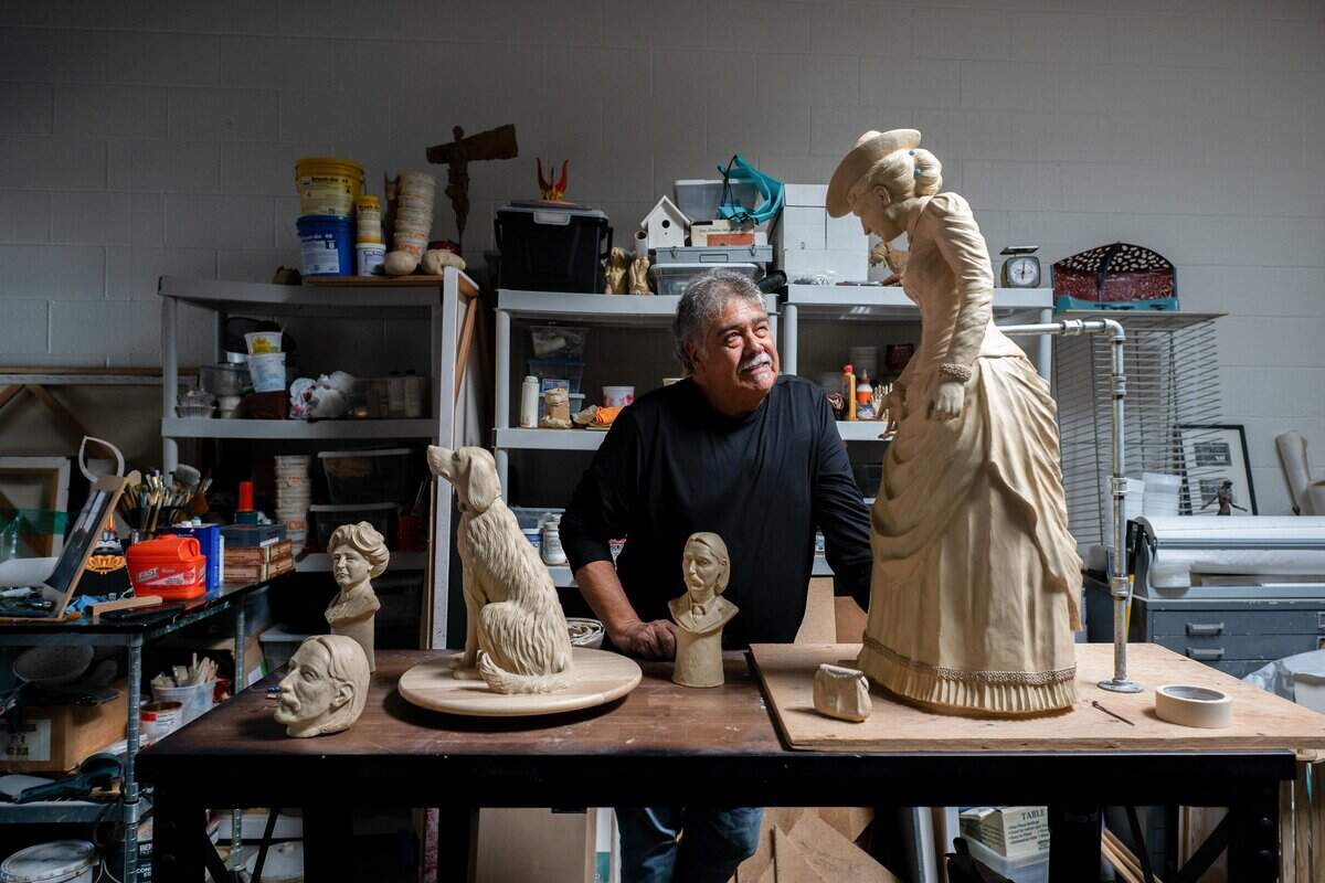 Sculptor Garr Ugalde gazes up at a model of Fanny Osbourne Stevenson as he stands among models of Robert Louis Stevenson and the Stevensons' dog, Chuchu, in his Sacramento studio last month. Ugalde is creating a life-size bronze composition of Stevenson, his wife, Fanny, and Chuchu.