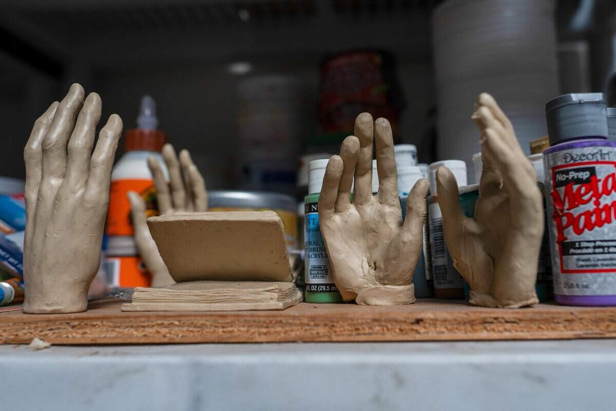 Models of hands created by sculptor Garr Ugalde for a life-size bronze composition of Robert Louis Stevenson, Fanny Osbourne Stevenson and their dog, Chuchu, are on display in his studio in Sacramento last month.