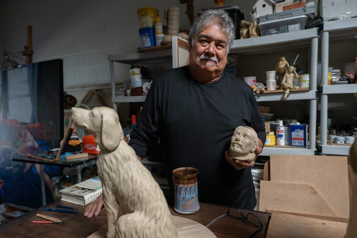 Sculptor Garr Ugalde holds a small model of Robert Louis Stevenson's head for what will become a life-size bronze sculpture of Stevenson in his studio in Sacramento last month. Stevenson, along with his wife, Fanny Osbourne Stevenson, and their dog, Chuchu, are the subjects of the Robert Louis Stevenson Public Art Project sculpture.