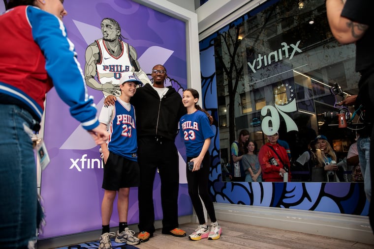 Tyrese Maxey posed with fans during meet-and-greet at the NBA Tip-Off fan celebration at the Xfinity store on Walnut Street in Philadelphia.
