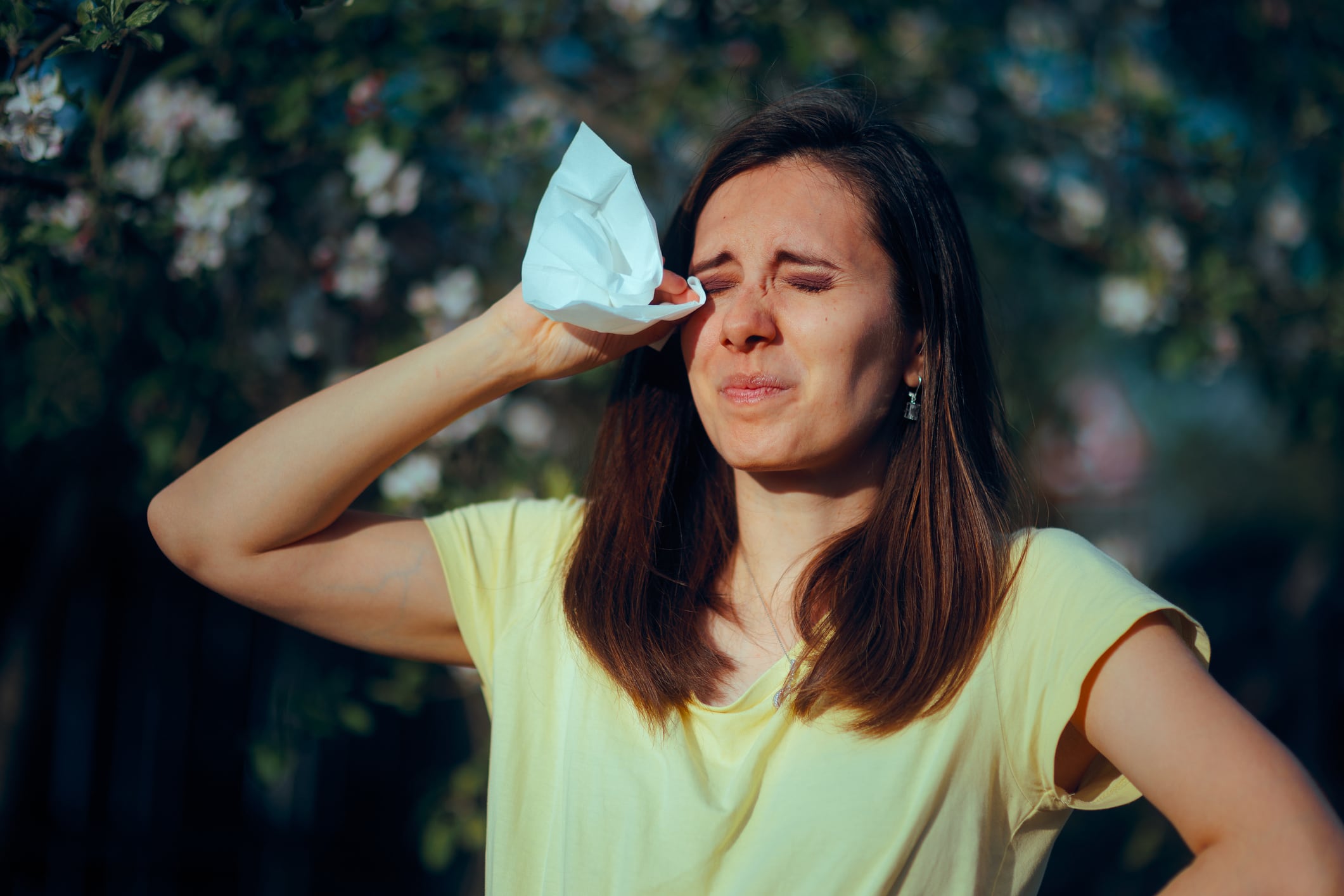 Woman having watery eyes from hay fever