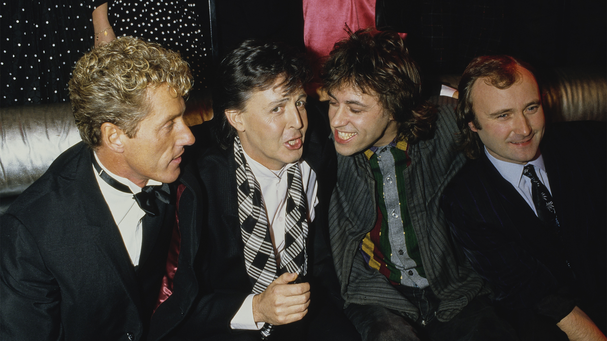 (L-R) English singer Roger Daltrey, English musician Paul McCartney, Irish singer-songwriter Bob Geldof, and English singer Phil Collins attend a party held after the 13th Annual American Music Awards in Los Angeles, California, 27th January 1986. The Award of Appreciation was presented to Geldof on the night by Roger Daltrey for organising the benefit concert, Live Aid.