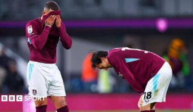 Burnley's Kyle Walker with a claret shirt over his face and Hjalmar Ekdal looking to the ground with his hands on his knees after defeat by Wolves