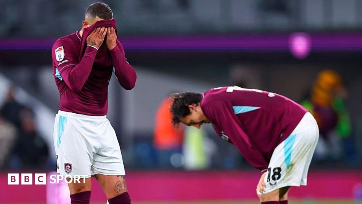 Burnley's Kyle Walker with a claret shirt over his face and Hjalmar Ekdal looking to the ground with his hands on his knees after defeat by Wolves