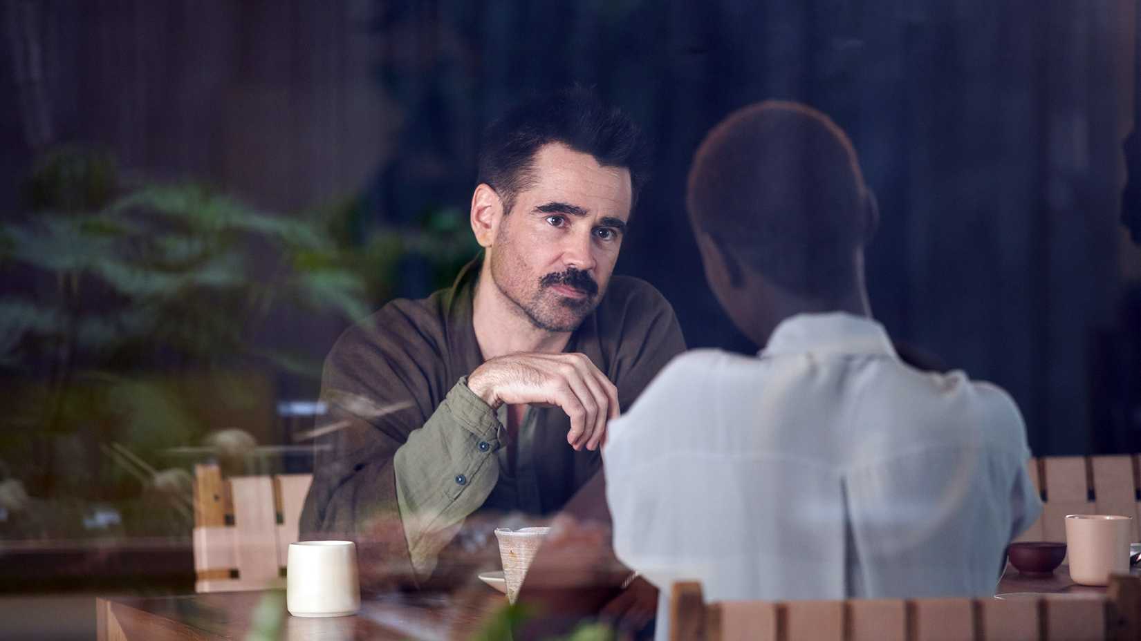 Colin Farrell sitting in a cafe in the A24 sci-fi movie After Yang (2021)