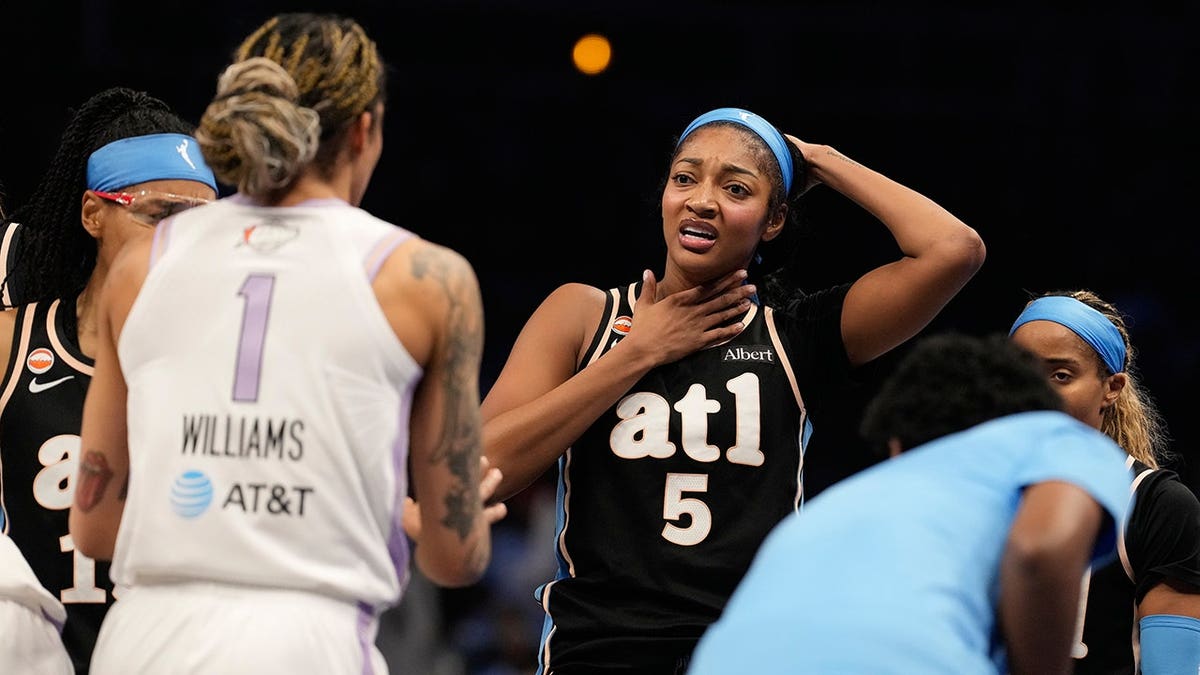 Angel Reese reacts after diving for the ball during WNBA Finals Game 3.