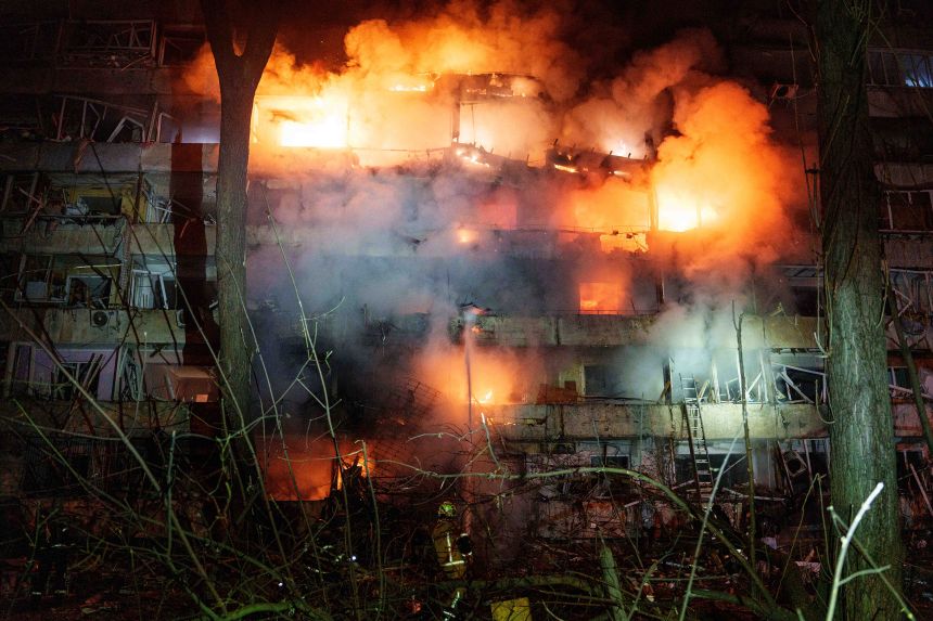 A damaged multi-story residential building in Kyiv is seen on fire following a Russian missile strike on October 13, 2026.