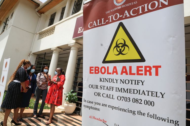 Health workers and officials stand outside an Ebola isolation facility in Kenya, October 7, 2026 [Andrew Kasuku/AP Photo]