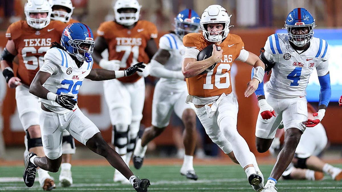 Arch Manning runs with the ball against Ole Miss defenders.