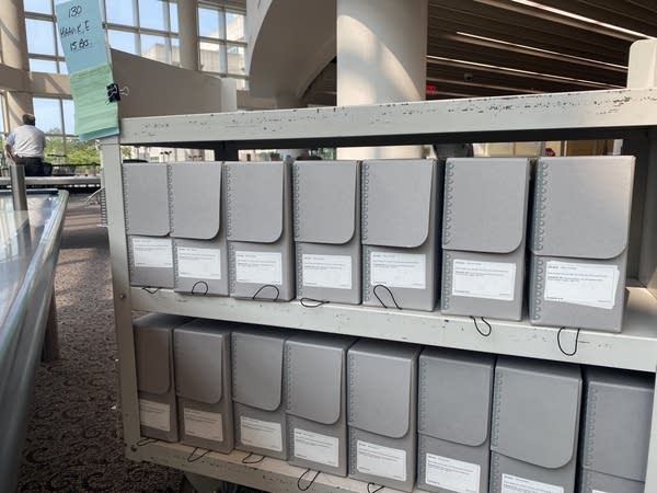 A cart of file folders holds many boxes.