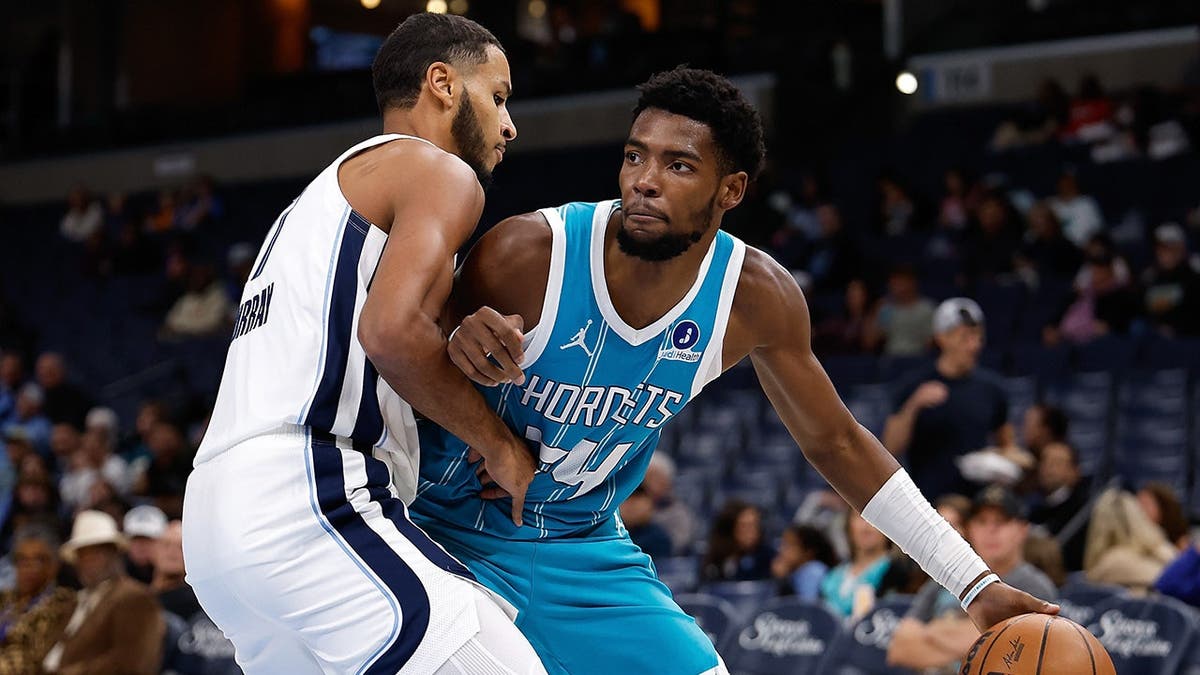 Brandon Miller #24 handles the ball during a preseason game against the Memphis Grizzlies.