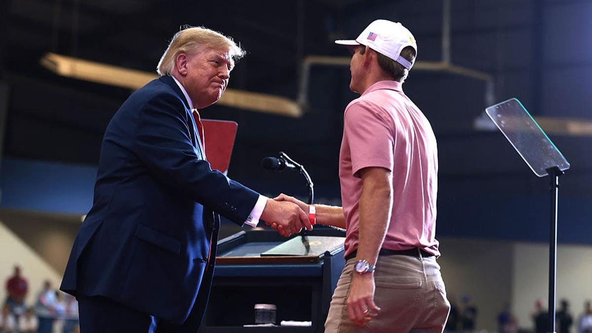 U.S. President Donald Trump shakes hands with professional golfer Jacob Bridgeman