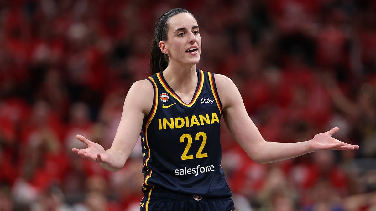 Caitlin Clark #22 reacts after being charged with a foul during an Indiana Fever WNBA Playoffs game.