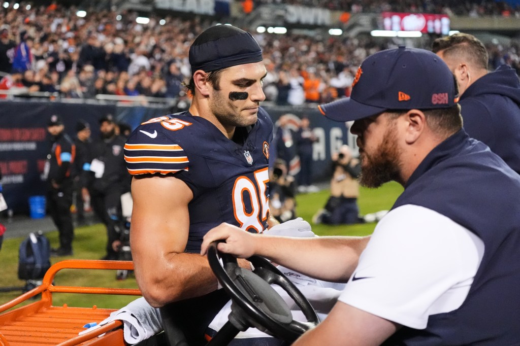 Chicago Bears tight end Cole Kmet (85) is carted off the field after suffering an injury.