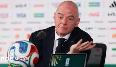 Gianni Infantino pictured at a news conference at the 2026 Fifa World Cup in front of a football.