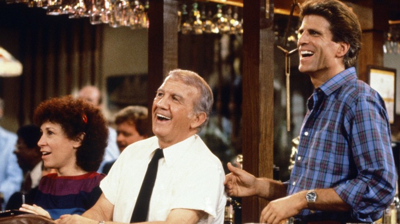 Carla, Coach, and Sam happily tending bar in Cheers