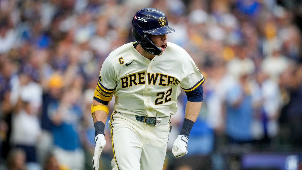 Christian Yelich runs after hitting a two-RBI base hit during Game 2 of the National League Championship Series.