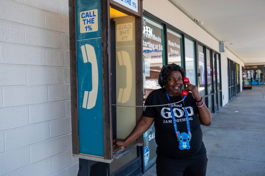 A woman talks on a free payphone installed in the Watts neighborhood of Los Angeles. The phone is connected to another in trendy Venice, another L.A. neighborhood by the beach.