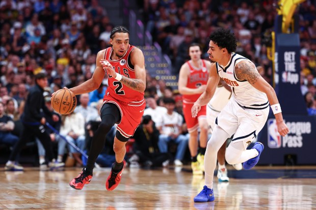 Noa Essengue of the Chicago Bulls dribbles against Julian Strawther of the Denver Nuggets during the first quarter in a preseason game at Ball Arena on Oct. 11, 2026, in Denver. (Tyler McFarland/Getty Images)