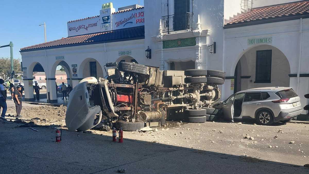 Two people hospitalized after truck crashes through barricade