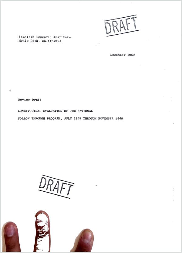 A document that says DRAFT. Three fingers are seen holding the page to a scanner.