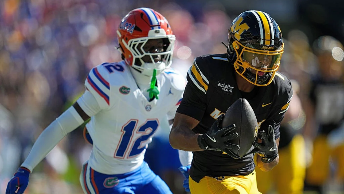 Donovan Olugbode catches a pass against Ben Hanks III during the first half at Faurot Field.