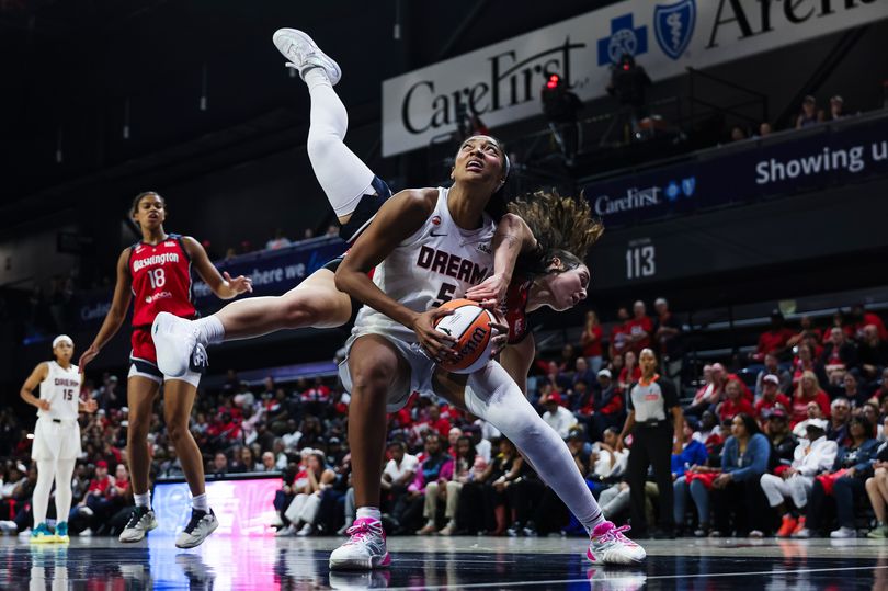 Angel Reese #5 of the Atlanta Dream is fouled by Georgia Amoore #8 of the Washington Mystics.
