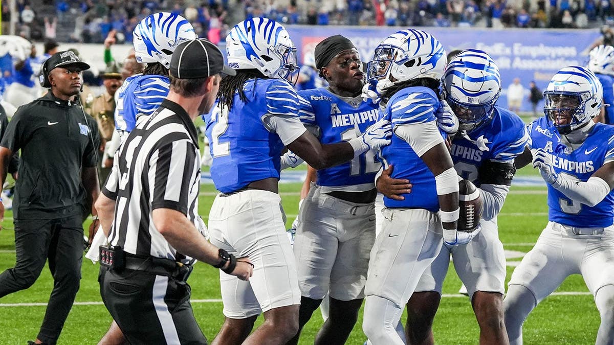 Ellis Ellis Jr. is celebrated by teammates after an interception in the end zone.