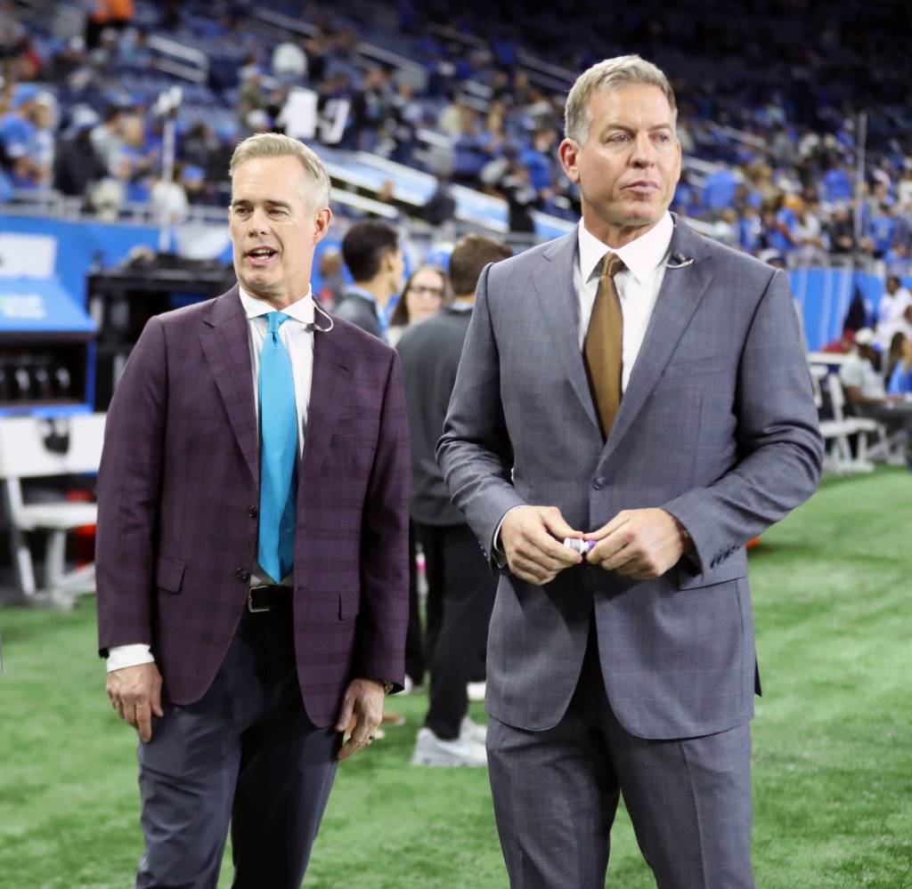 ESPN/ABC Monday Night Football commentators Joe Buck and Troy Aikman stand on the field before a game.
