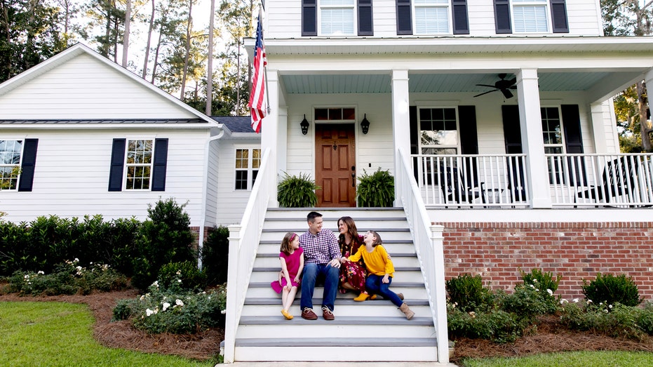 Family in front of house.