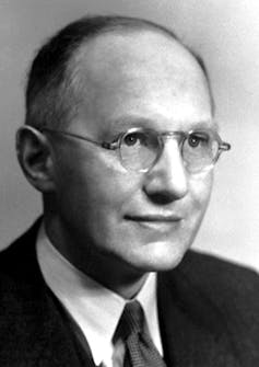 A vintage headshot of a man wearing glasses