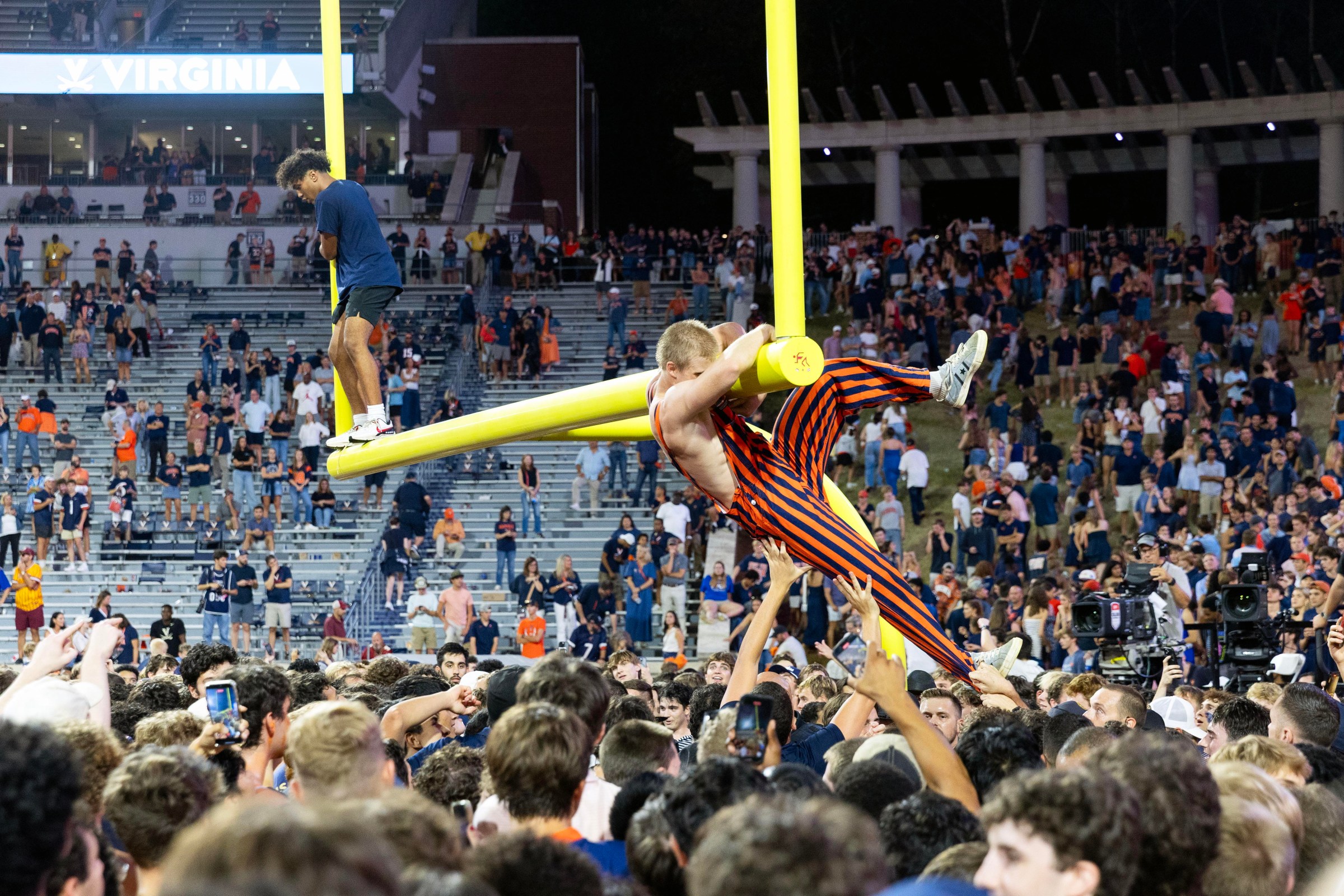 CHARLOTTESVILLE, VIRGINIA - SEPTEMBER 26: Fans of the Virginia Cavaliers rush the field to celebrate after a game against the Florida State Seminoles at Scott Stadium on September 26, 2025 in Charlottesville, Virginia. (Photo by Ryan M. Kelly/Getty Images)