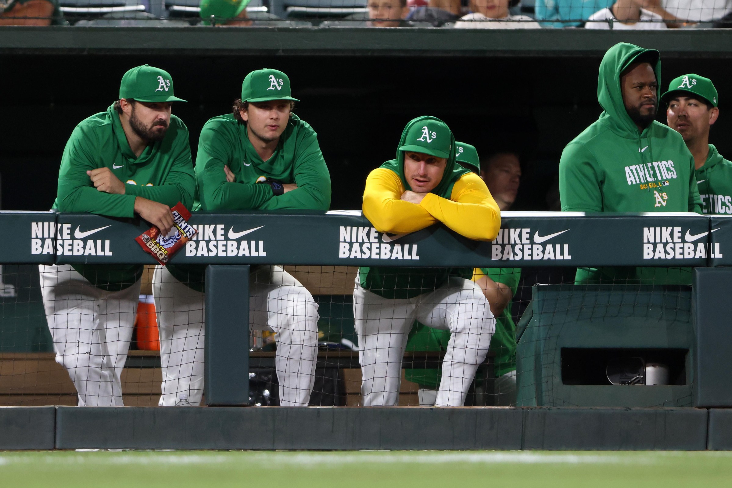 SACRAMENTO, CALIFORNIA - AUGUST 14: Shea Langeliers #23 of the Athletics, Nick Kurtz #16 of the Athletics, Brent Rooker #25 of the Athletics, and Luis Serverino #40 of the Athletics look on from the dugout during the ninth inning against Texas Rangers at Sutter Health Park on August 14, 2026 in Sacramento, California. (Photo by Scott Marshall/Getty Images)