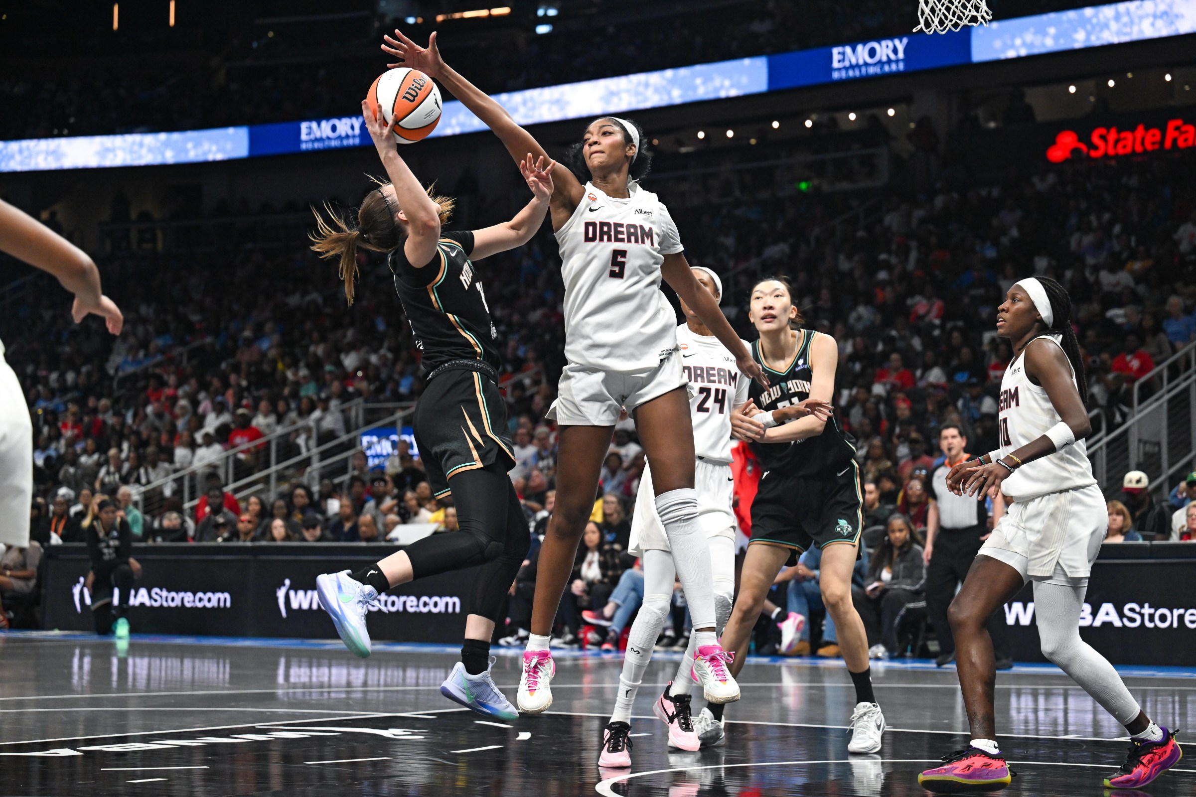 Angel Reese blocks Sabrina Ionescu.