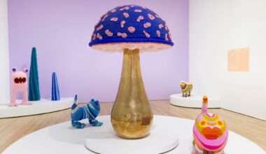 fantastical creatures and a large gold and purple mushroom by the haas brothers