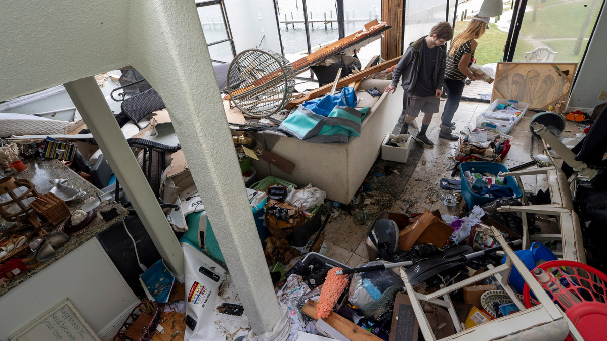 Laura and Alex Dean clean out their home that was severely damaged during Hurricane Isaias.Hurricane Isaias made landfall Friday, October 9 along the U.S. Gulf coast.