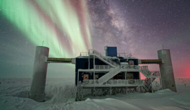 an icebound building in the dark night of the Antarctic, with stars and an aurora in the background