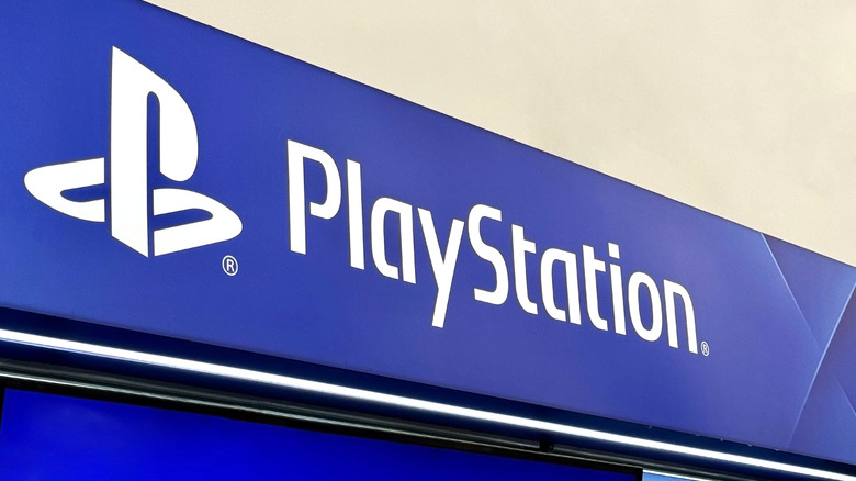 Sony PlayStation logo at the top of a building as a banner in blue and white text
