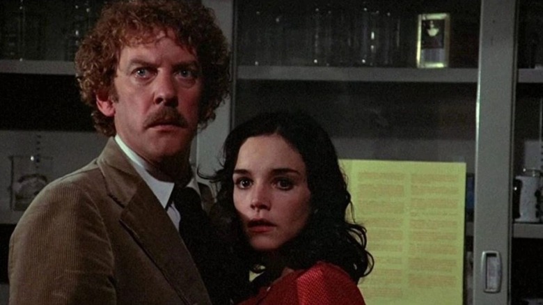 Donald Sutherland as Matthew Bennell and Brooke Adams as Elizabeth Driscoll in Invasion of the Body Snatchers, standing next to each other.