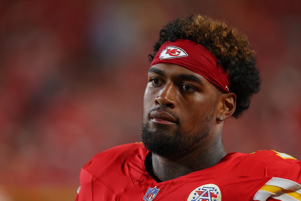 Kansas City Chiefs player Josh Simmons #71 watches from the sidelines.