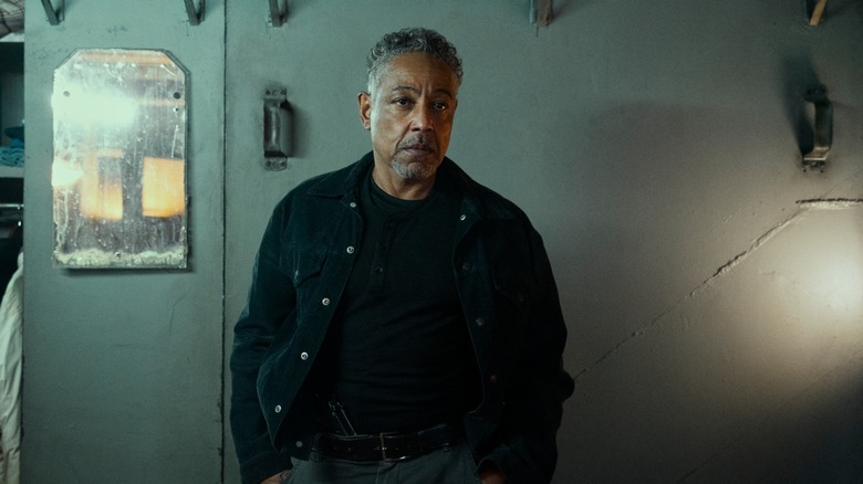 Ray Vernon (aka Leo Pap) looks ahead of him, hands in his pockets, in 