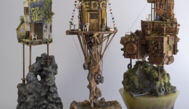 three sculptures by Simon Laveuve in 1/35 scale of ramshackle, dystopian houses built on stilts and rocky outcrops