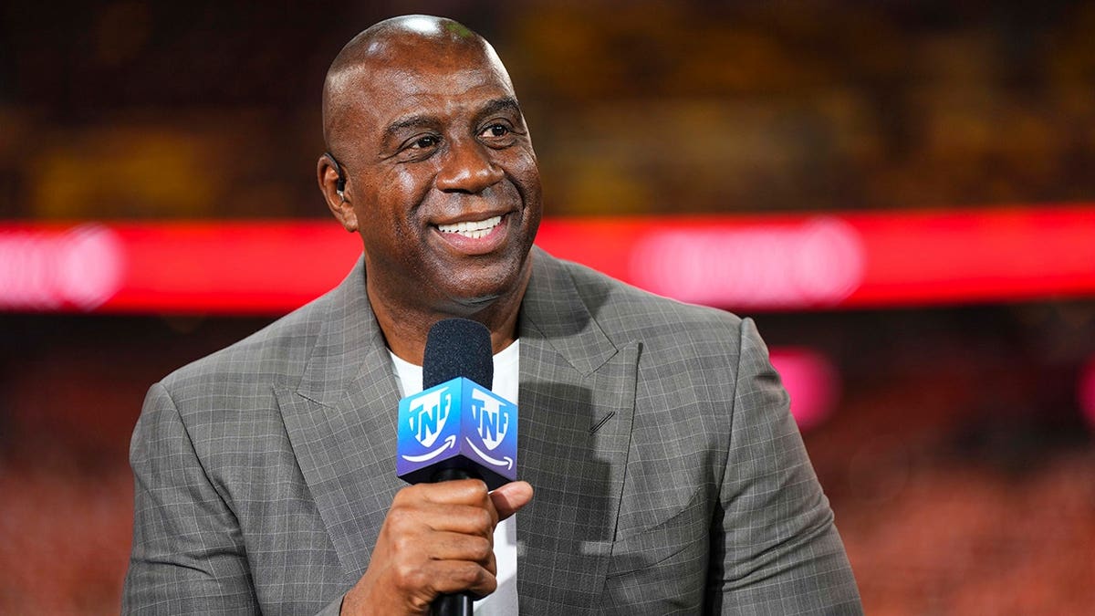 Magic Johnson stands on the set of a pregame show at FedEx Field.