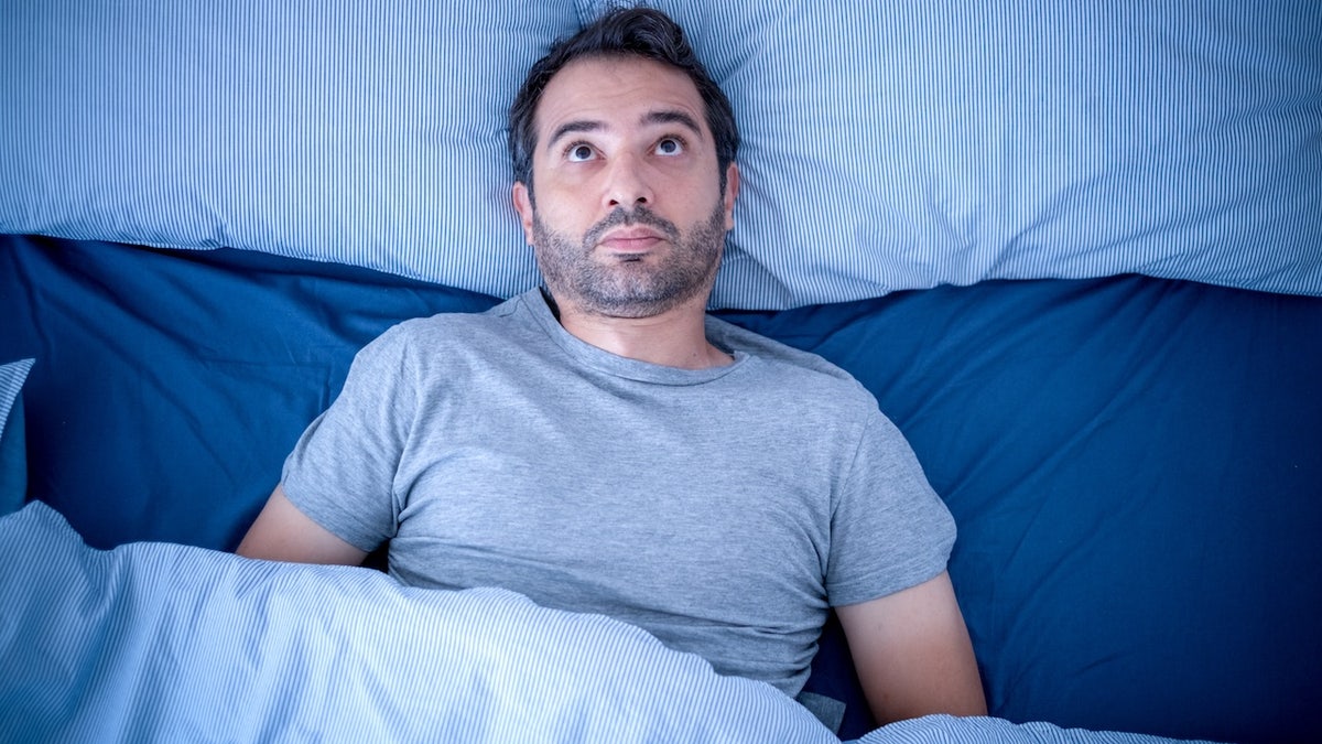 Man awake at night can't sleep