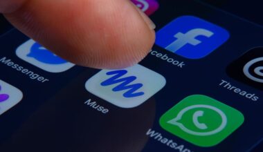 A close-up of a human finger pressing the Muse app icon inside a folder containing Meta apps on a smartphone screen.