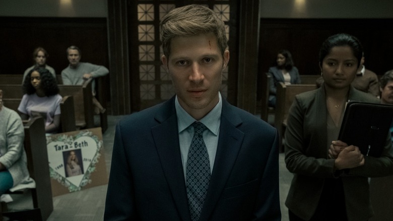 Riley Flynn stands in a courtroom in 